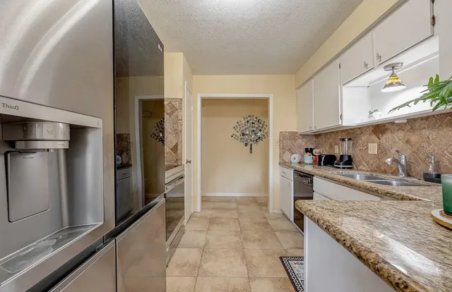 a kitchen with a stove and a refrigerator