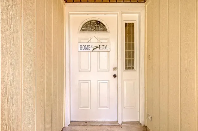a view of front door with wooden door