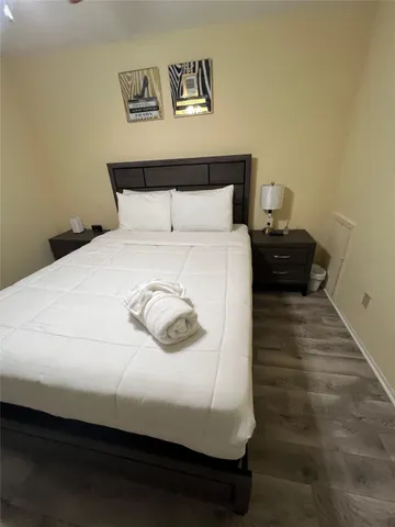 a large bed sitting in a bedroom next to a cabinet