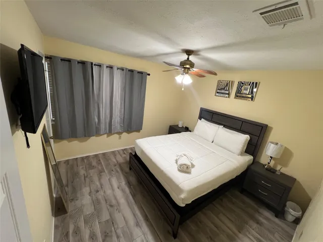 a bed sitting in a bedroom next to a cabinet
