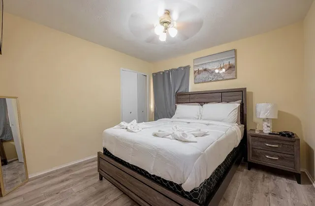 a bed sitting in a bedroom next to a bathroom