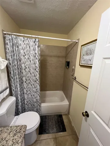 a bathroom with a toilet and a mirror