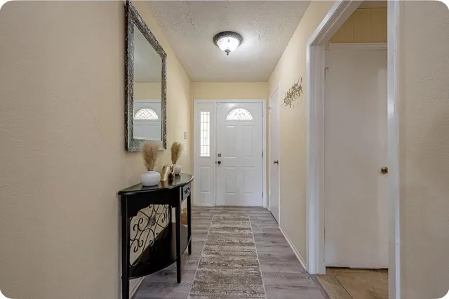 a view of an entryway with wooden floor