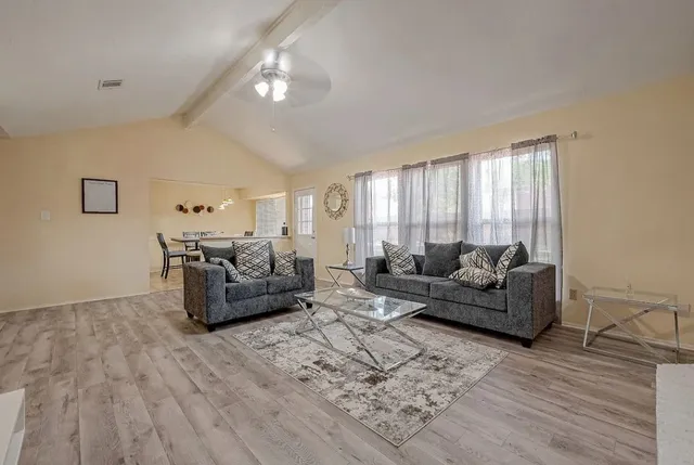 a view of a dining room with furniture and window