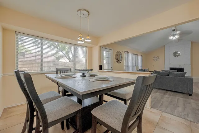 a view of a a dining room with furniture and a chandelier