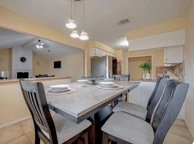 a view of a dining room with furniture and window