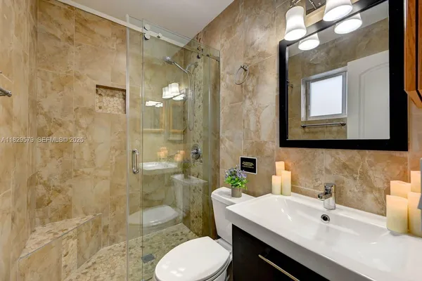 a bathroom with a sink toilet and shower