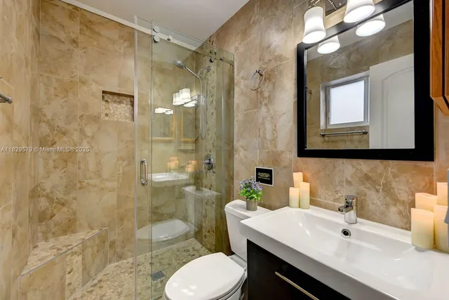 a bathroom with a sink toilet and shower