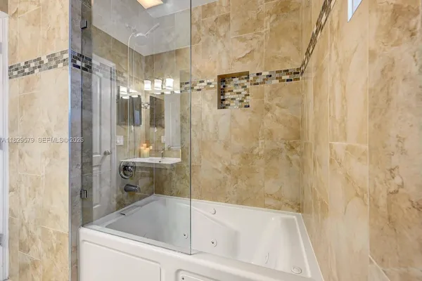 a bathroom with a bathtub and a shower
