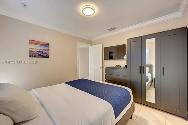 a bedroom with a large bed and a tv