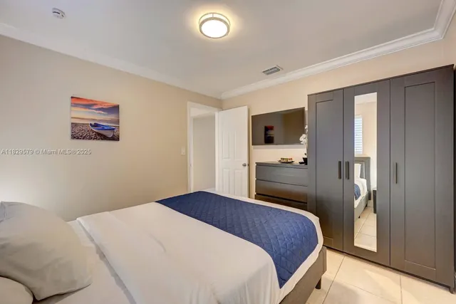 a bedroom with a large bed and a tv