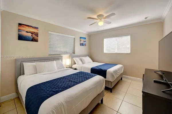 a bedroom with bed and a chandelier