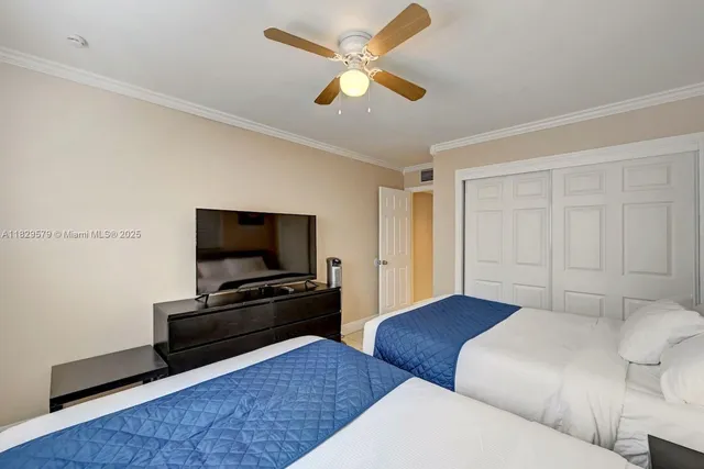 a bedroom with furniture and a flat screen tv