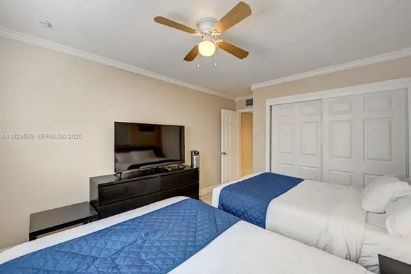 a bedroom with furniture and a flat screen tv