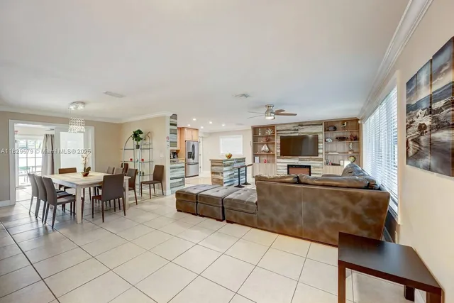 a living room with furniture a dining table and chairs
