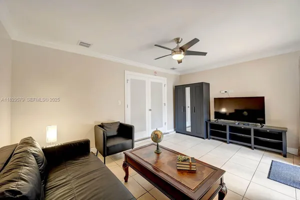 a living room with furniture and a flat screen tv