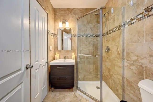 a bathroom with a granite countertop shower mirror and a sink