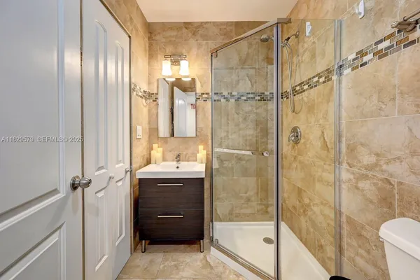 a bathroom with a granite countertop shower mirror and a sink