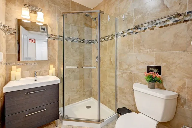 a bathroom with a sink toilet and shower