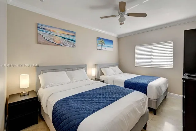 a bedroom with beds and a chandelier