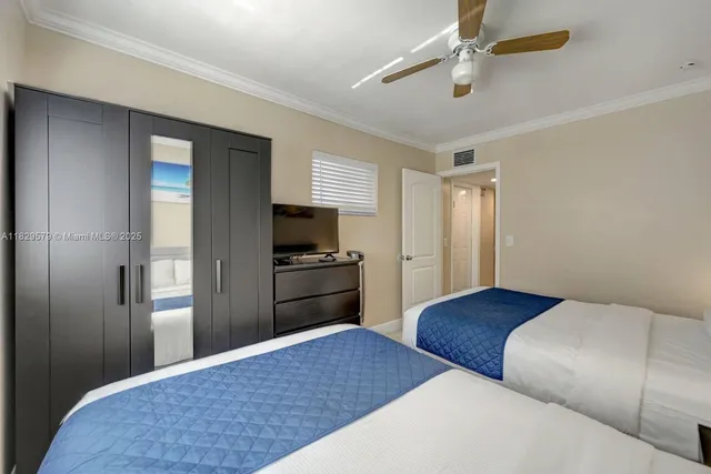 a bedroom with a bed and a television