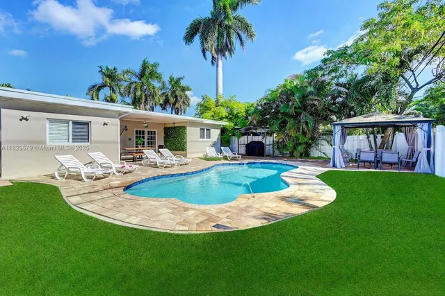 a view of a house with swimming pool and porch