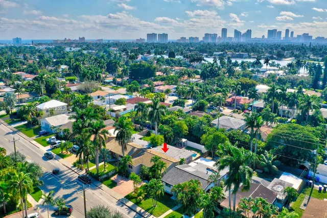 an aerial view of residential houses with city view