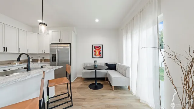 a living room with furniture a rug and white walls