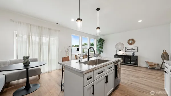 a kitchen with stainless steel appliances granite countertop a stove and a sink