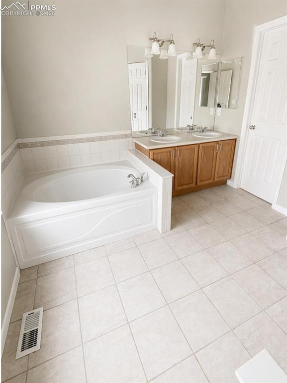 9212 Oakmont Road Peyton, CO 80831 - Photo 14 of 23 a spacious bathroom with a bathtub and shower