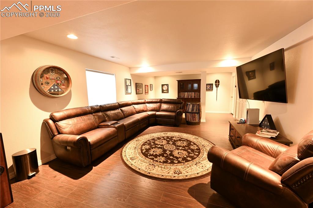 9212 Oakmont Road Peyton, CO 80831 - Photo 16 of 23 a living room with furniture and a flat screen tv
