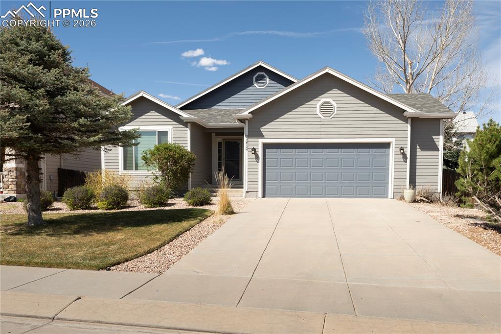 9212 Oakmont Road Peyton, CO 80831 - Photo 2 of 23 a front view of a house with a yard and garage