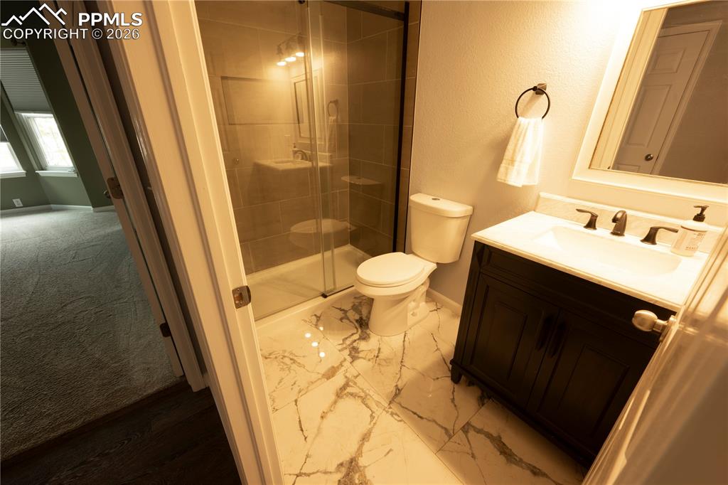 9212 Oakmont Road Peyton, CO 80831 - Photo 22 of 23 a bathroom with a sink and a mirror