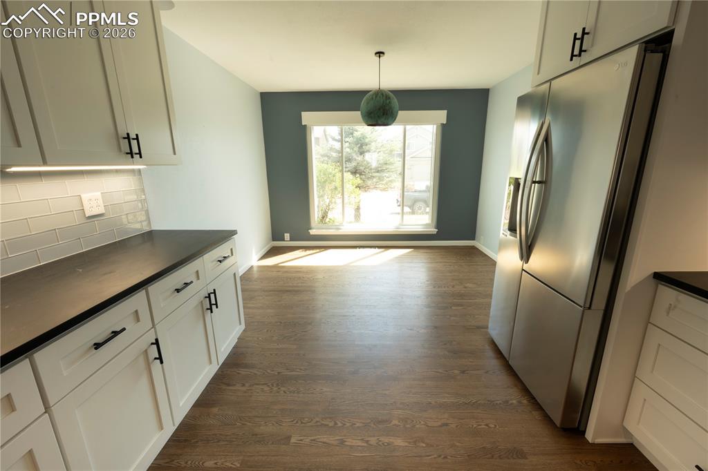 9212 Oakmont Road Peyton, CO 80831 - Photo 23 of 23 a kitchen with stainless steel appliances granite countertop a refrigerator a sink and a stove