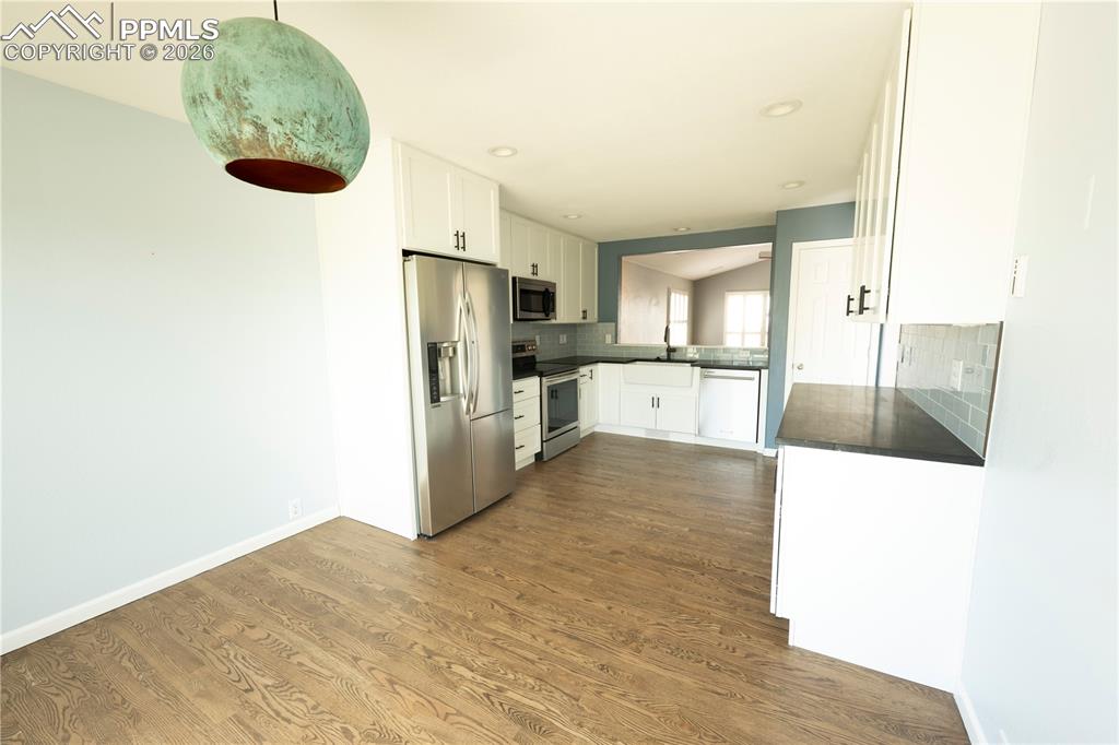 9212 Oakmont Road Peyton, CO 80831 - Photo 5 of 23 a view of kitchen with refrigerator microwave and cabinets
