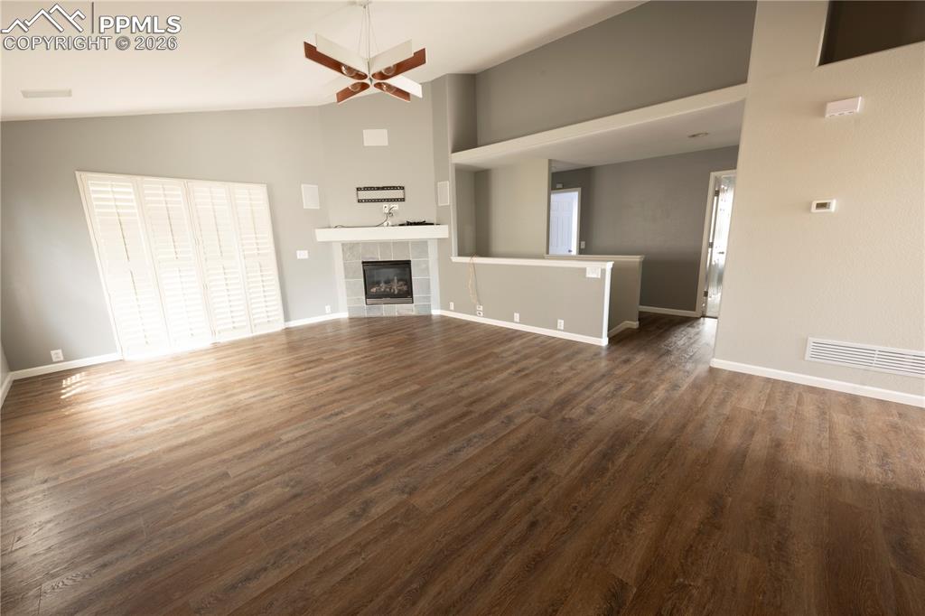 9212 Oakmont Road Peyton, CO 80831 - Photo 7 of 23 a view of a livingroom with wooden floor and a kitchen