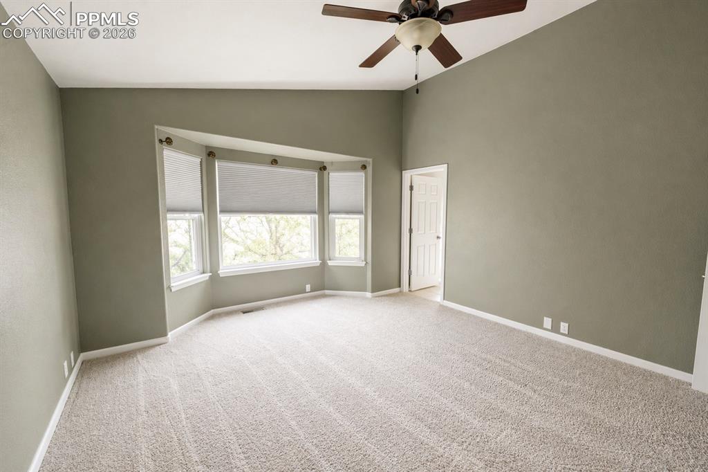 9212 Oakmont Road Peyton, CO 80831 - Photo 9 of 23 an empty room with a window and a fan