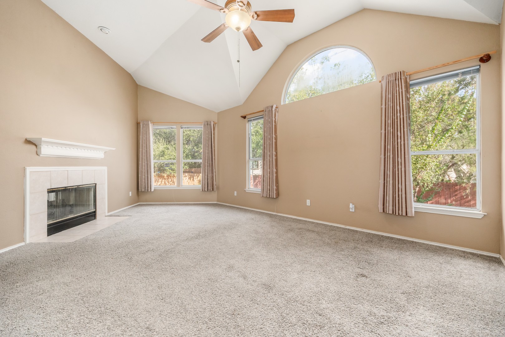 1108 Antelope Ridge Cedar Park, TX 78613 - Photo 9 of 39 An inviting fireplace complements the soaring vaulted ceilings and expansive windows of this spacious interior.