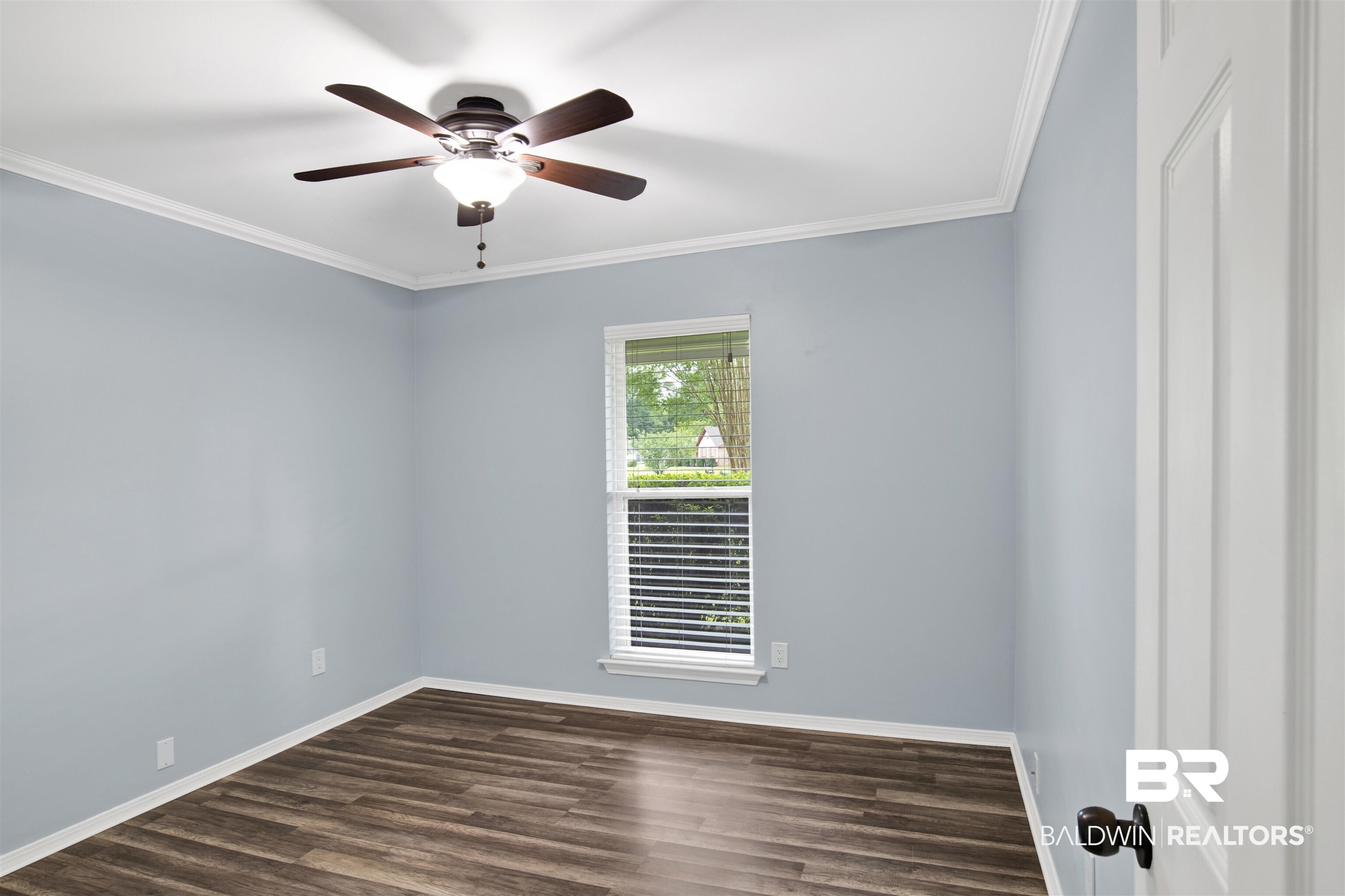 3011 Olde Gate Road Mobile, AL 36695 - Photo 22 of 35 Empty room with dark wood-style flooring, a ceiling fan, and crown molding