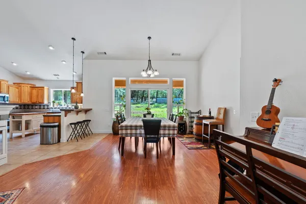 a kitchen with stainless steel appliances granite countertop a stove a sink dishwasher and a microwave oven with large cabinets