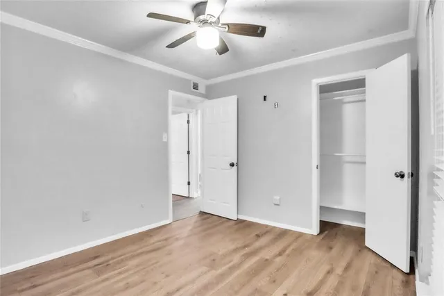 a view of an empty room and wooden floor