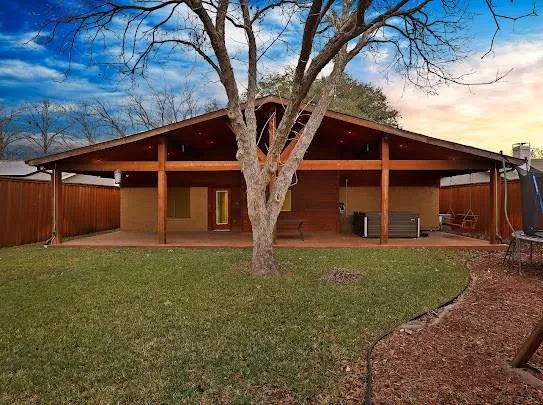 a view of a house with a large tree