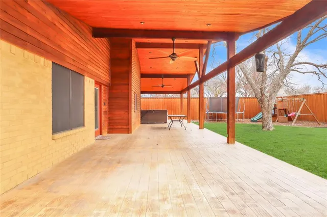 a view of an house with backyard and a tree