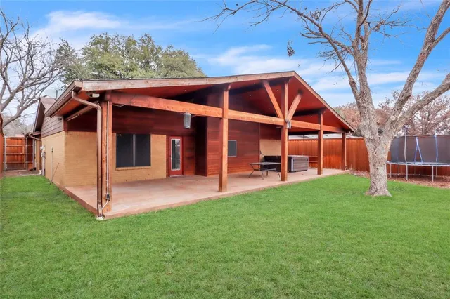a view of an house with backyard porch and furniture