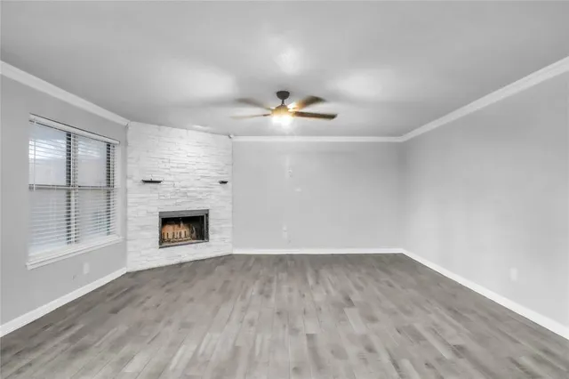 a view of an empty room with a fireplace and a window