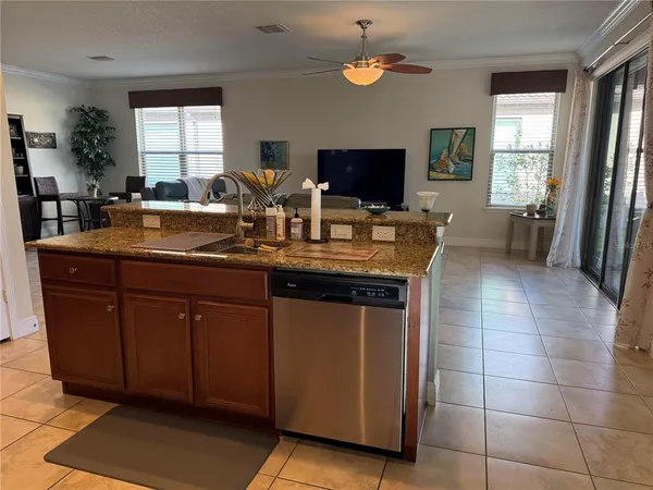 a kitchen with stainless steel appliances granite countertop a sink and a white cabinets
