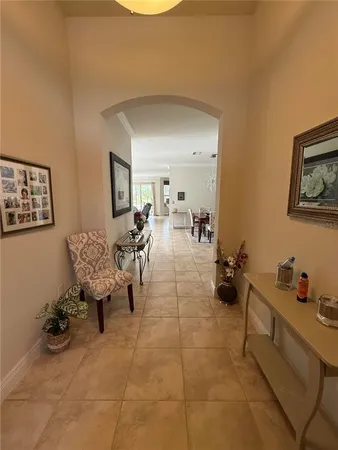 a living room with furniture a floor to ceiling window and a flat screen tv