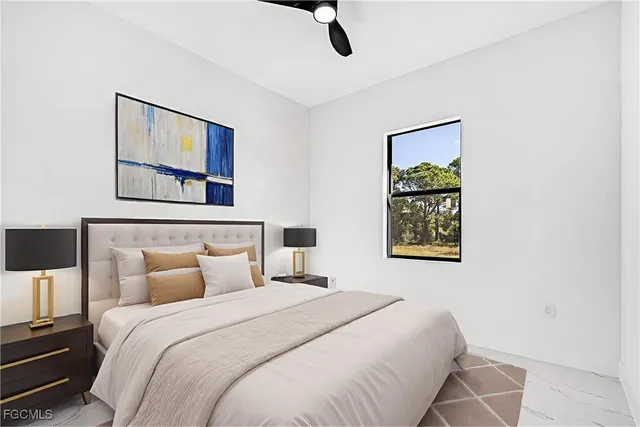 a bedroom with a bed and a painting on the wall