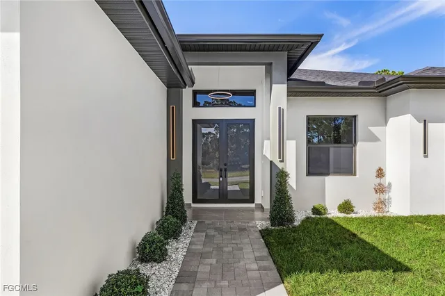 a front view of a house with a garden