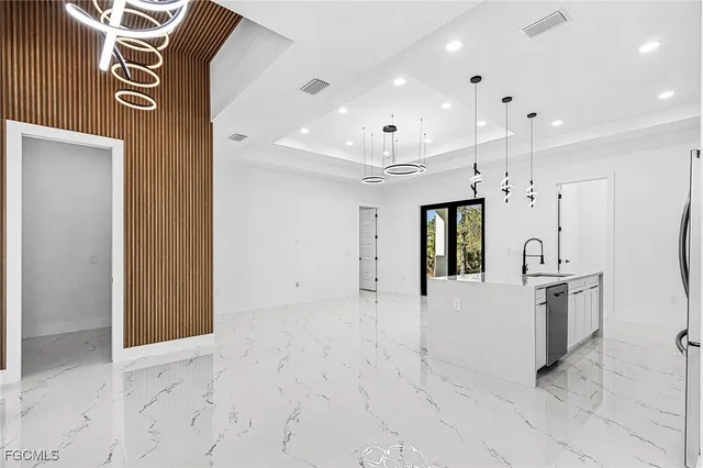 a view of a hallway with stainless steel appliances granite countertop furniture